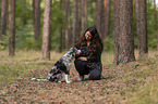 woman and Miniature Australian Shepherd