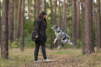 woman and Miniature Australian Shepherd
