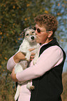 woman kisses Parson Russell Terrier