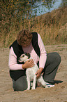 woman snuggles with Parson Russell Terrier
