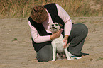 woman fondles Parson Russell Terrier