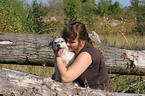 woman snuggling with Parson Russell Terrier