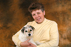 woman snuggles with Parson Russell Terrier