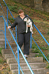 woman is carriing a Parson Russell Terrier