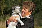 woman carries a Parson Russell Terrier