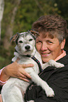 woman carries a Parson Russell Terrier