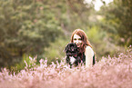 Pekingese with woman in the heath