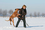 woman with Rhodesian Ridgeback in the snow