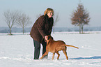 woman with Rhodesian Ridgeback in the snow