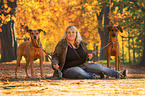 woman and 2 Rhodesian Ridgebacks