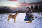 woman and Shiba Inu