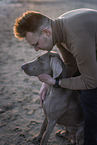 man and Weimaraner