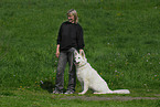 woman and white swiss shepherd