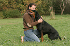 woman is fondling Doberman Pinscher