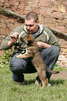 man and mongrel puppy