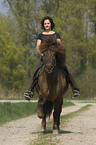woman rides pony