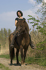 woman rides pony