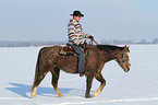 man rides American Paint Horse