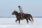 man rides American Paint Horse