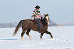 man rides American Paint Horse