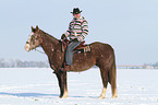 man rides American Paint Horse
