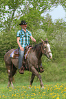 man rides American Paint Horse