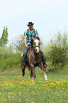 man rides American Paint Horse