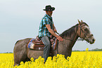 man rides American Paint Horse