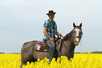 man rides American Paint Horse