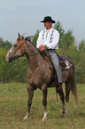 man rides American Paint Horse