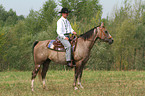 man rides American Paint Horse