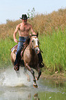 man rides American Paint Horse