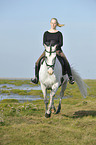 woman rides Andalusian horse
