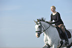 woman rides Andalusian horse