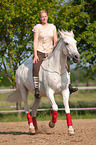 woman rides Andalusian horse