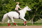 woman rides Andalusian horse