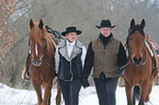 man and woman with horses