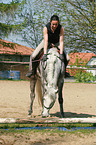 woman rides arabian horse