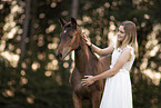 woman and Austrian warmblood foal