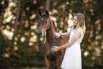 woman and Austrian warmblood foal