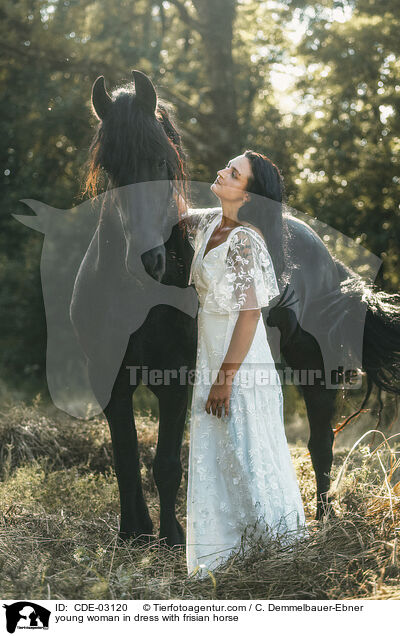 young woman in dress with frisian horse / CDE-03120