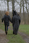 woman and Frisian horse