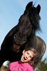girl and Friesian horse