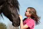 girl and Friesian horse