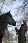 woman and Frisian horse
