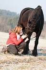 girl and Friesian horse