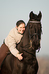 woman and Friesian horse