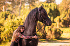 girl and Frisian horse