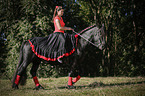 woman rides Friesian Horse