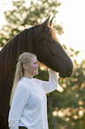 woman and Frisian horse